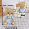 A cute, light blue bear cake topper with a brown body and features for a birthday or baby shower.
