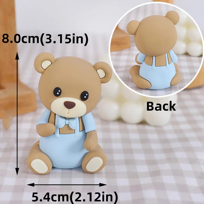 A cute, light blue bear cake topper with a brown body and features for a birthday or baby shower.