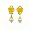 A pair of golden heart-shaped dress-up accessories featuring yellow glitter and pearl drops.