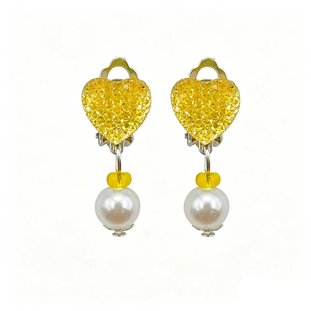 A pair of golden heart-shaped dress-up accessories featuring yellow glitter and pearl drops.