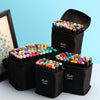 A collection of alcohol markers in black pouches, showing various colors and tips.