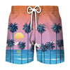 Men's beach swim shorts with a tropical coconut tree print in pink and blue tones.
