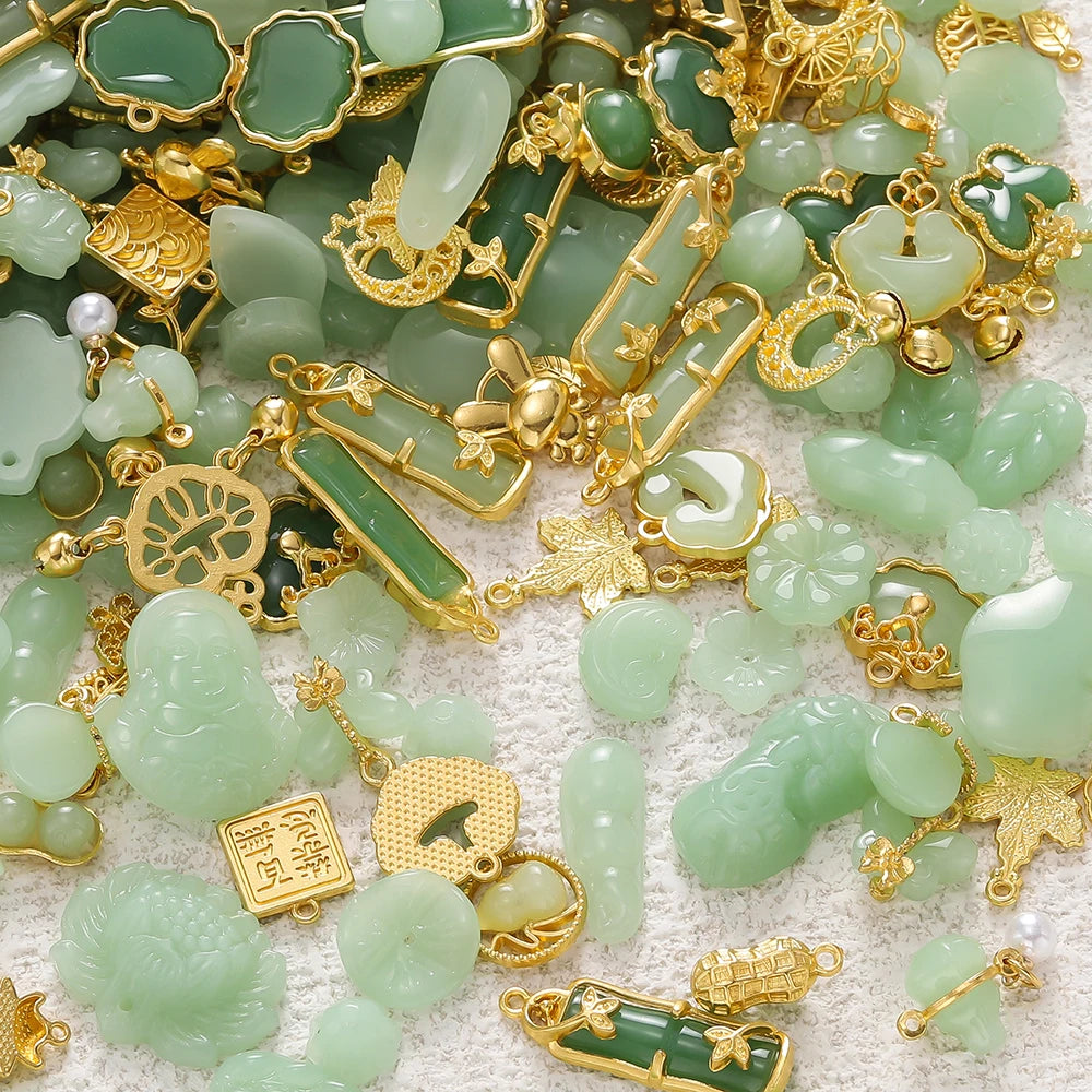 A collection of green imitation jade charms and beads in various shapes and sizes, set against a white background.