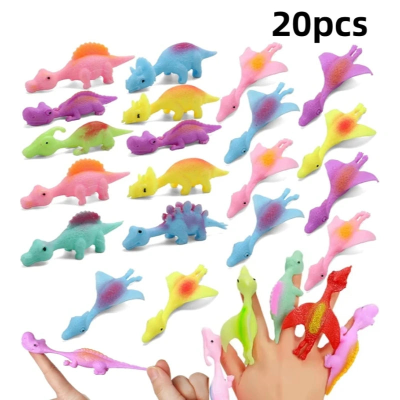 A collection of 20 colorful rubber dinosaur slingshot toys in various colors and shapes held by a hand.