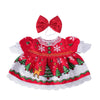 A festive red and white Christmas-themed dress for a child featuring a bow and seasonal patterns.