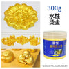 A jar of water-based glitter paint with gold and silver sparkle, next to a molded gold flower and a golden Buddha figure.