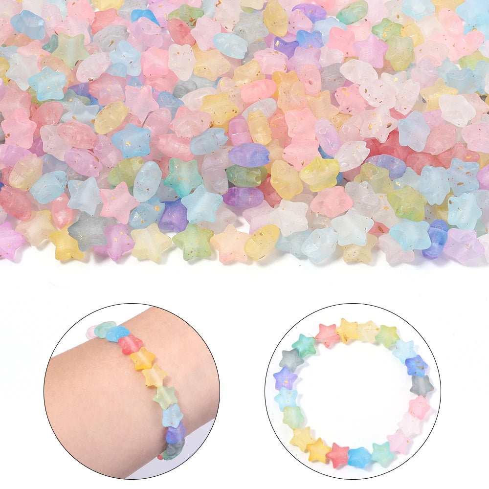 A close-up of a large quantity of colorful transparent star acrylic beads for jewelry making, with examples of finished brace