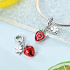 A silver bracelet chain with two fruit charm beads, one shaped like a strawberry and the other like a clover.