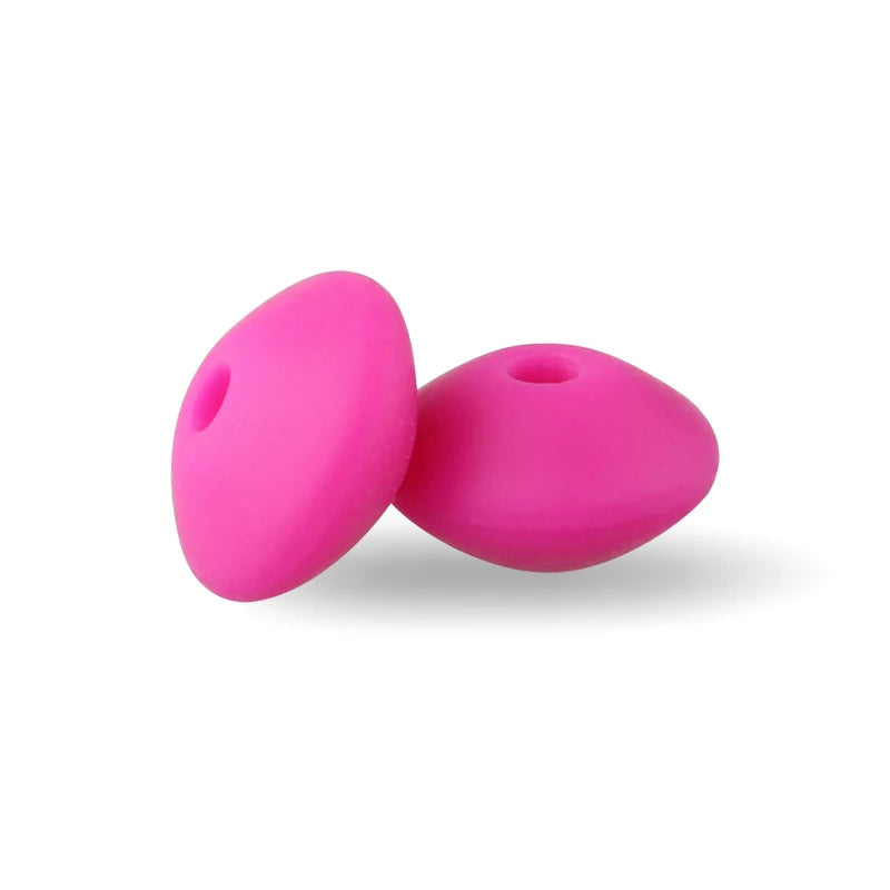 Two bright pink silicone lentil beads shaped like an abacus for jewelry making