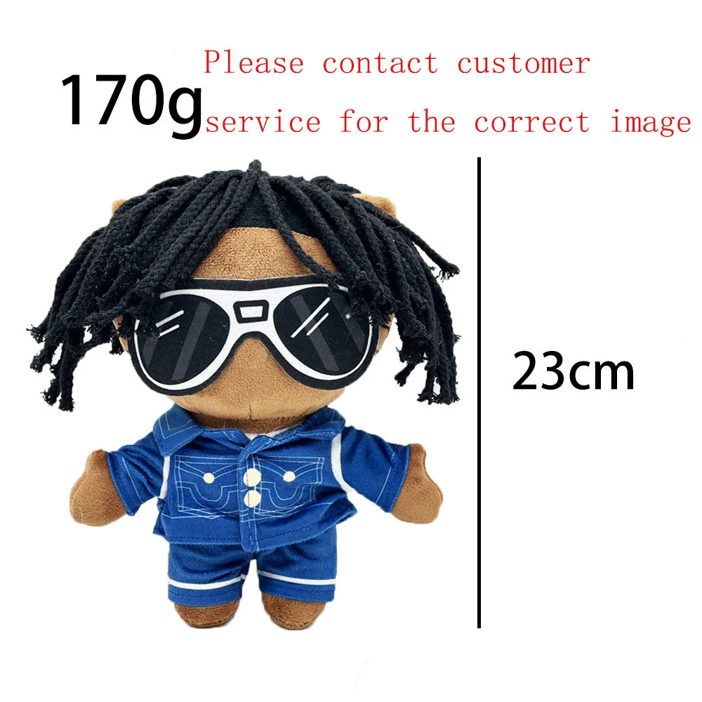 A plush doll of Eminem, XXXTentacion & Frank Ocean with black dreadlocks and sunglasses, wearing a blue shirt.