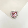 A heart-shaped pink gemstone surrounded by clear rhinestones for DIY crafts.