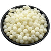 A pile of small, round, translucent white acrylic beads for jewelry making.