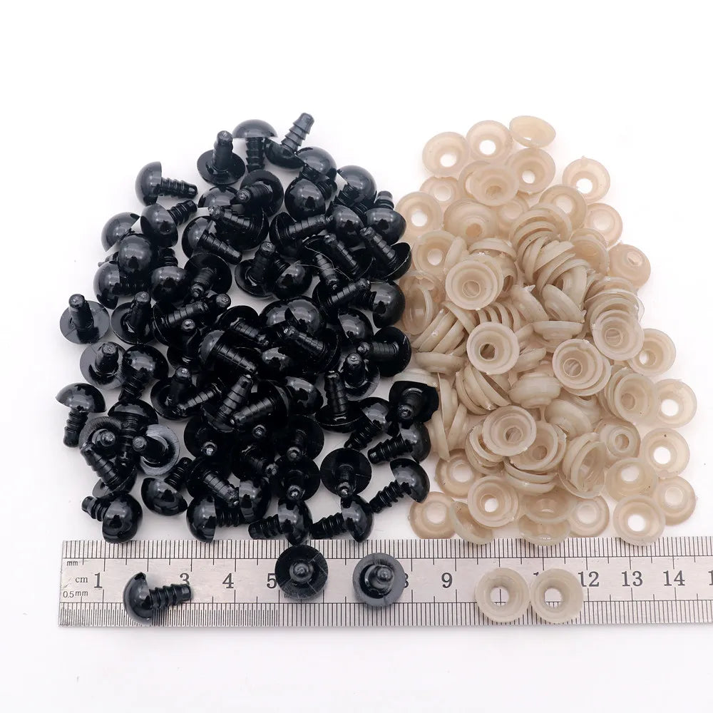 A collection of black and beige plastic safety eyes for amigurumi, including various sizes and locking washers.