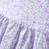 A purple baby girl summer dress featuring a white floral pattern and ruffled details.