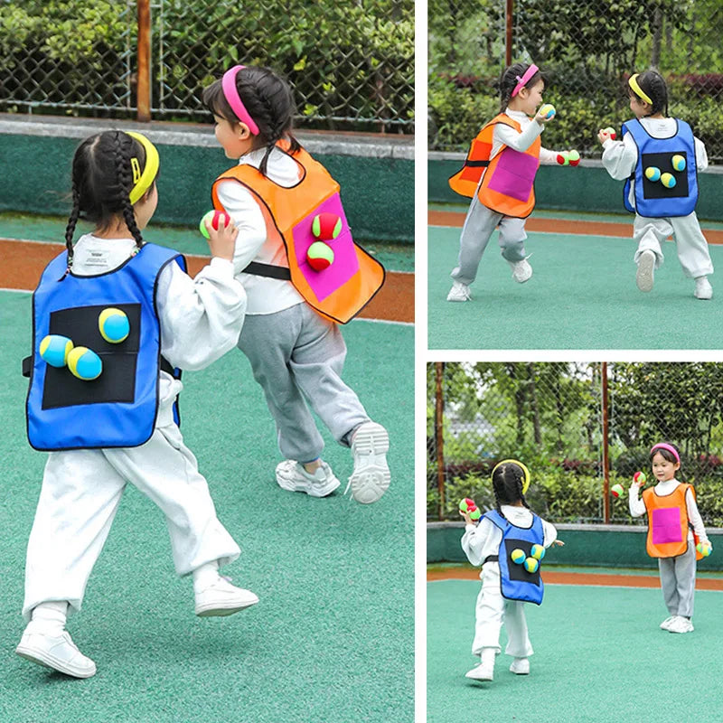 Two children wearing colorful sticky dodgeball vests playing an outdoor game