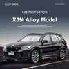 A black BMW X3M alloy model car in 1:32 proportion shown in a dynamic driving pose.
