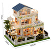 A wooden mini seaside villa dollhouse kit featuring a two-story structure with furniture and landscaping.