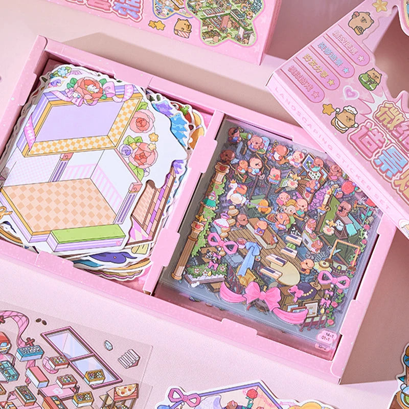 Pink box containing a sticker set of cartoon mini town diorama scenes for junk journals and scrapbooking