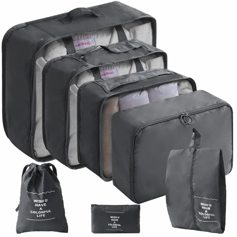 A set of black travel packing cubes and a storage bag with a colorful life design.