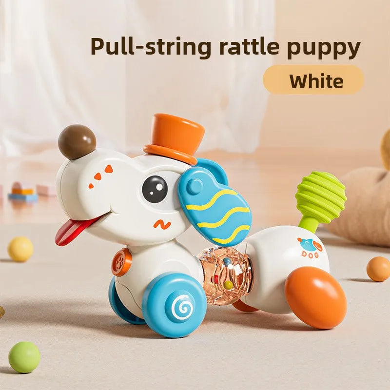 A white pull-string rattle puppy toy with orange and blue accents lying on a light surface.