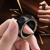 A hand is clicking a black magnetic fidget ring with gold accents onto a surface.