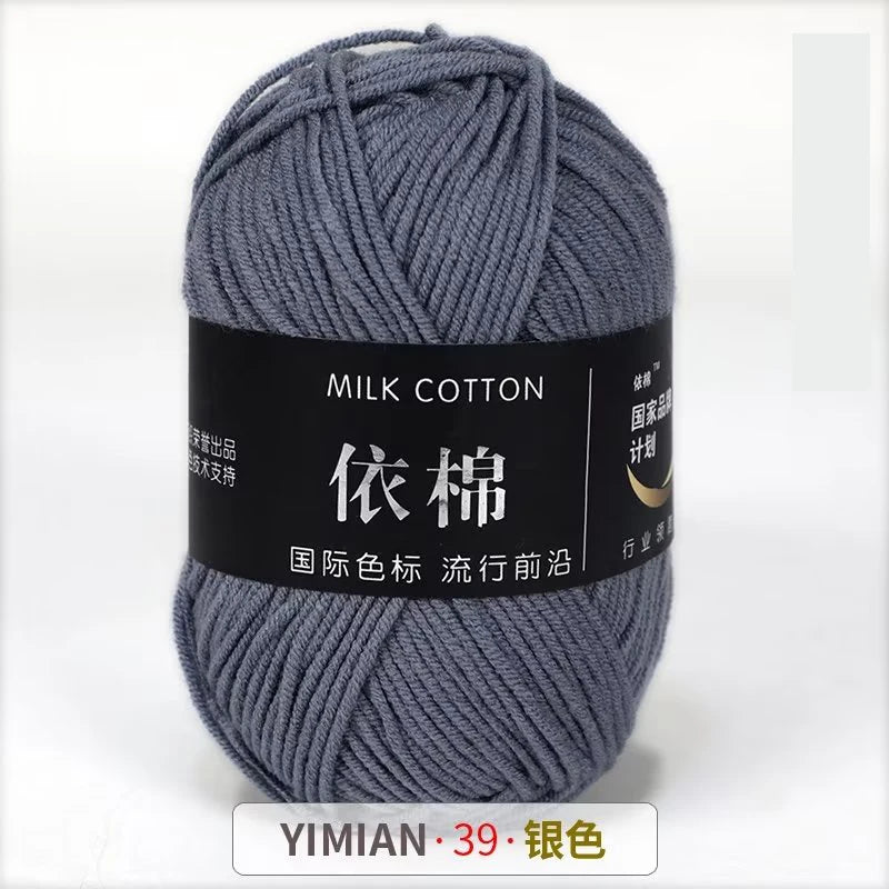 A ball of gray milk cotton yarn labeled with Chinese characters and a price tag.