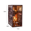 A dark wooden DIY book nook kit featuring a detailed miniature scene with warm LED lighting and architectural elements.