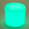 A translucent, glowing cyan slime product in a jar, casting a soft light on the surface.