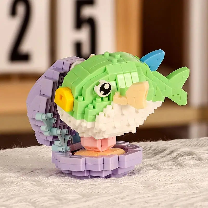 A green shark building block toy featuring a yellow eye and white snout, set against a blurred background.