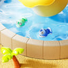 A yellow plastic bowl filled with colorful plastic fish is shown above a shallow blue water surface.
