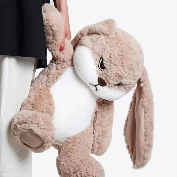 A fluffy, light brown giant angry rabbit plush toy being held by a person.