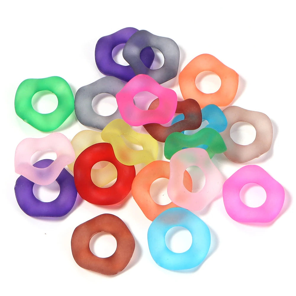Assortment of colorful acrylic spacer beads in various shades including purple, pink, green, and orange.