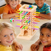 A group of children playing a wooden pumping stick game with colorful sticks and balls.