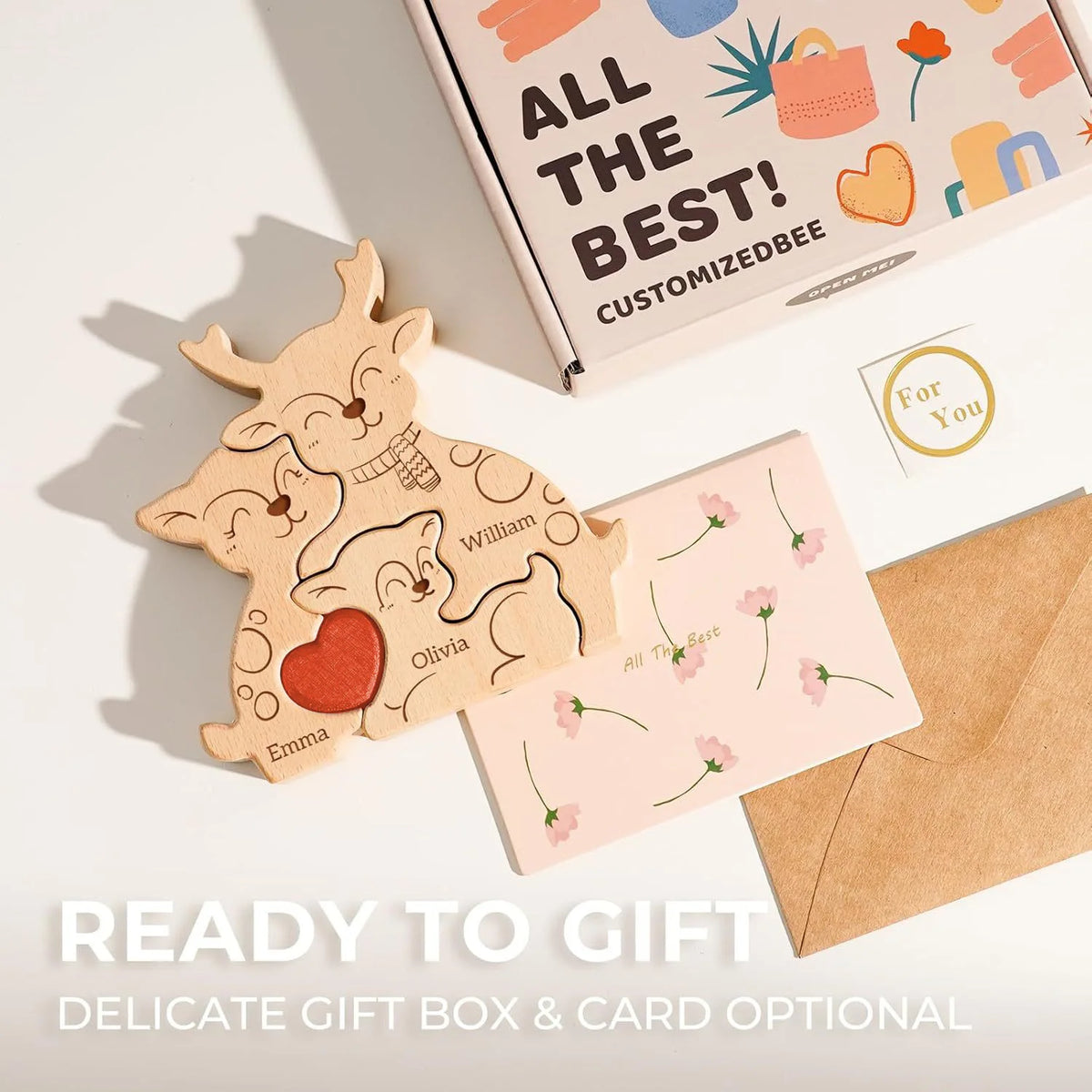 A wooden elk family name puzzle decoration is shown next to a gift box and an envelope.