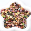 A pile of colorful Czech glass coffee bean beads for jewelry making