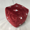 A deep red plush figure shaped like a cube with multiple white and red eyes.
