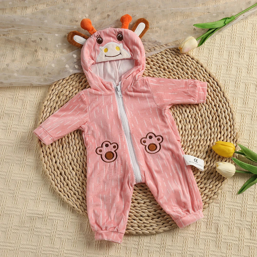 A pink hooded romper featuring a bear face design is laid on a woven mat.