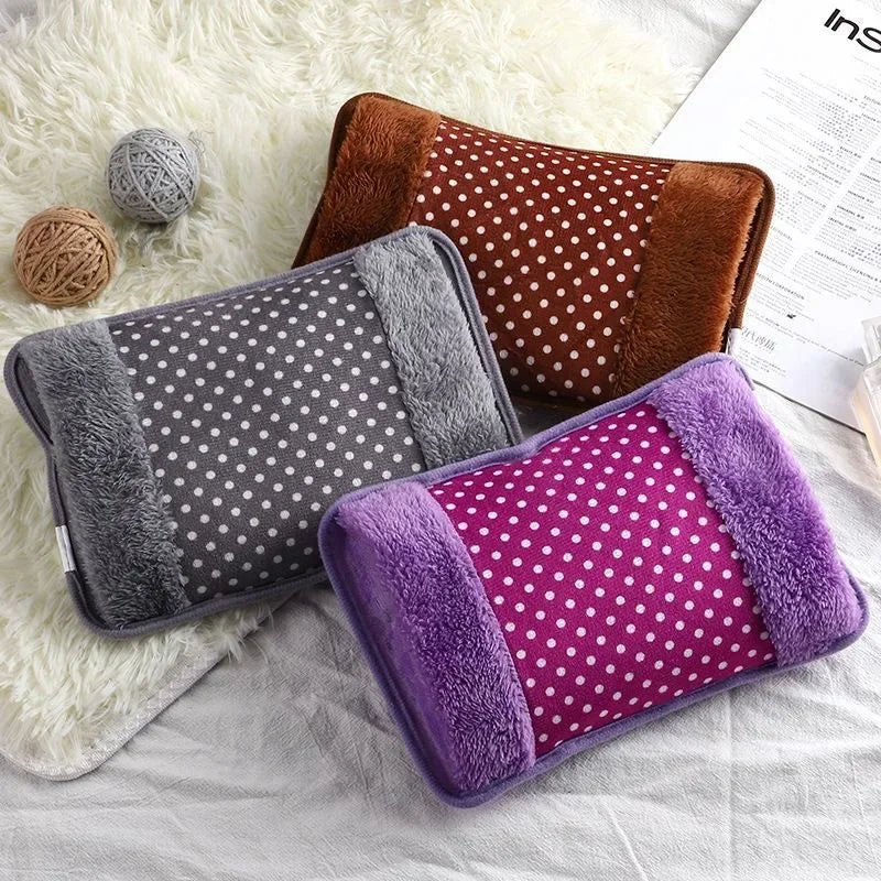 A collection of three cozy rechargeable hot water bottles with soft covers in brown, gray, and purple resting on a white fluf