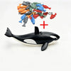 A set of ten randomly colored fish building blocks and one black and white shark model.