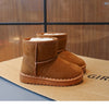 A pair of brown suede winter boots with white faux fur lining displayed on a cardboard box.