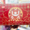 A red box featuring an illustration of a nine-tailed fox plush collectible with gold accents.