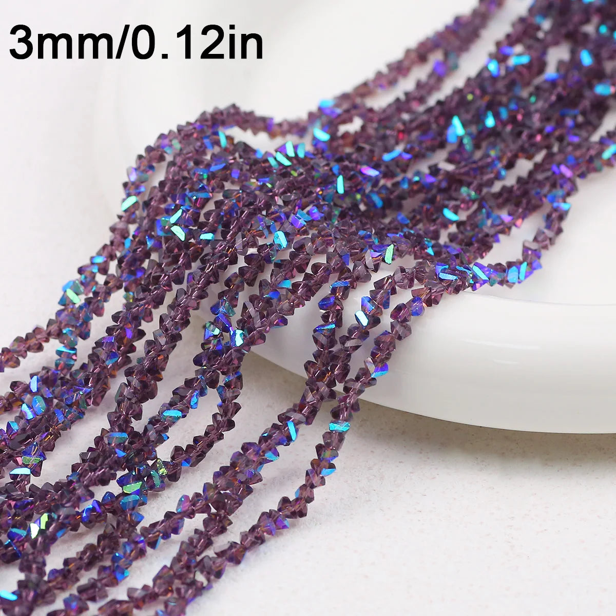 Purple and blue crystal triangle beads strung on a string for jewelry making