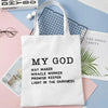 A white tote bag featuring the text My God Way maker miracle worker promise keeper light in the darkness
