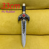 A silver dagger with an ornate black and gold hilt rests on a yellow fabric background.