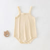 A beige lightweight cotton strappy romper for babies with vertical pleats.