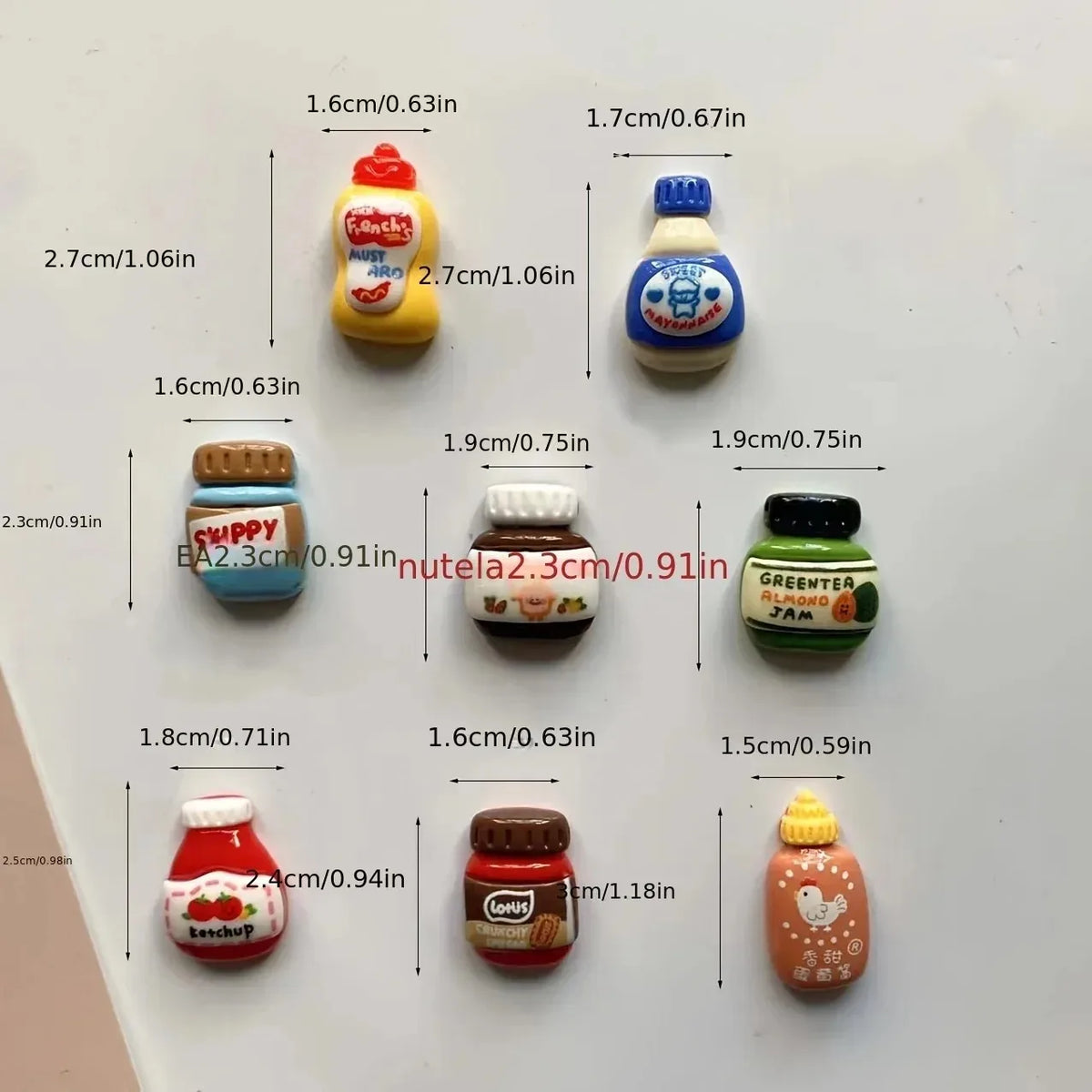 A set of eight kawaii jam jar fridge magnets in various colors and sizes displayed on a white surface.
