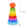 A stack of colorful wooden sensory blocks in rainbow order, topped with an orange ball and resting on a light blue base.