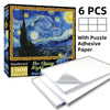A box of a 1000-piece jigsaw puzzle featuring a night sky landscape with adhesive paper sheets.