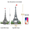 Comparison of small and big Eiffel Tower models made from LED-illuminated micro building blocks