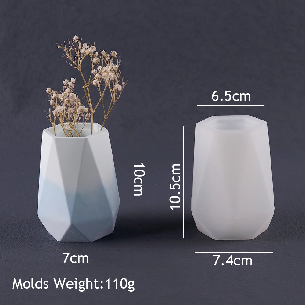 A white silicone mold shaped like a vase or planter, next to a dried floral sprig.